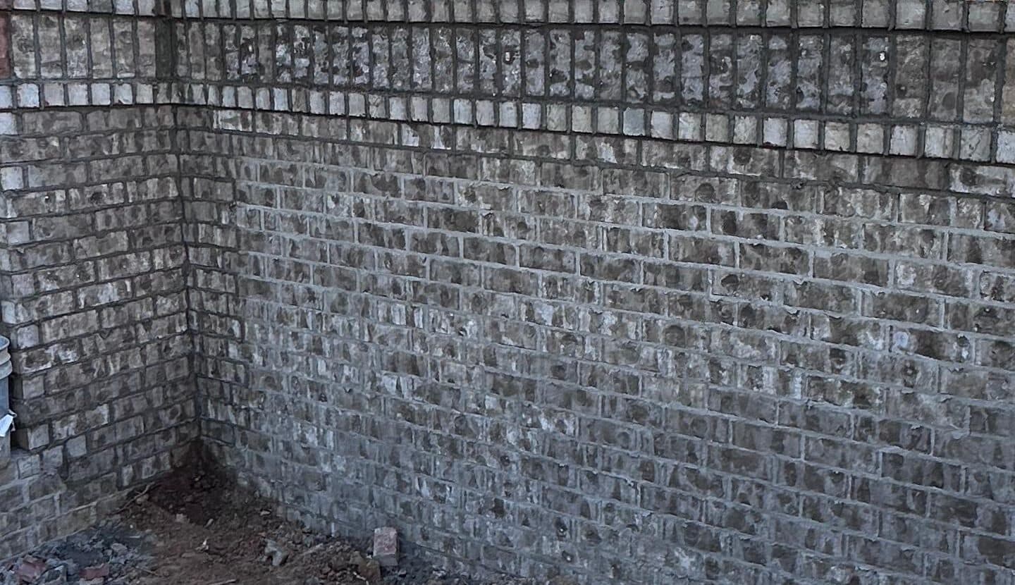 Corner of a finished brick wall with its cap course